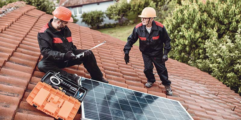 Monteure installieren Photovoltaikanlage auf einem Hausdach